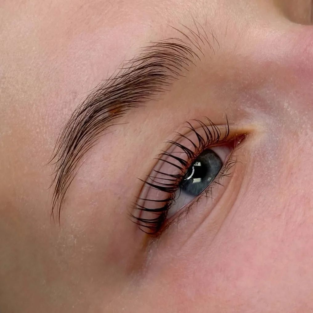 Laminated brows and lifted lashes, seen from the side