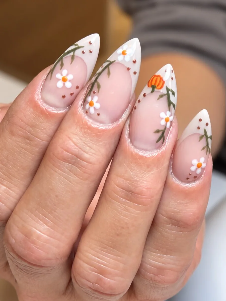 Almond nails with tiny daisies and pumpkins